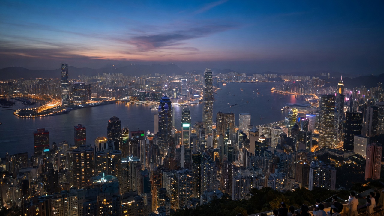 The view from Victoria Peak over Hong Kong at twilight, skyscrapers packed along both sides of the harbour with Kowloon beyond