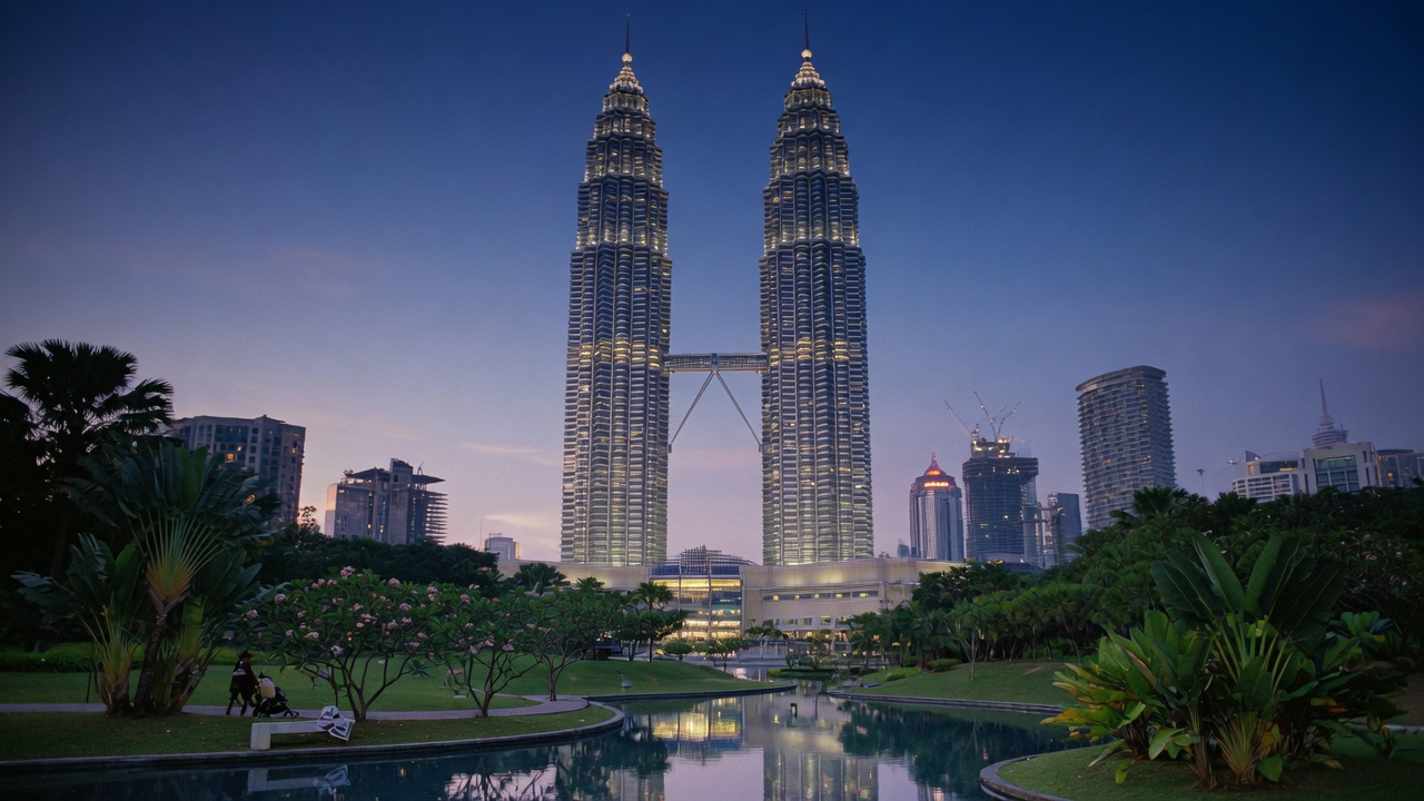 The Petronas Twin Towers rising above Kuala Lumpur at dusk