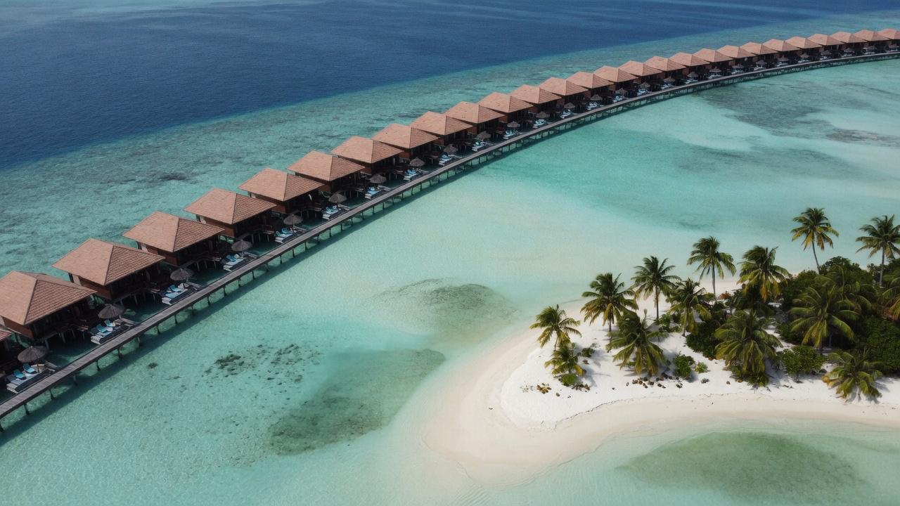 An overwater villa resort ringing a turquoise Maldivian atoll