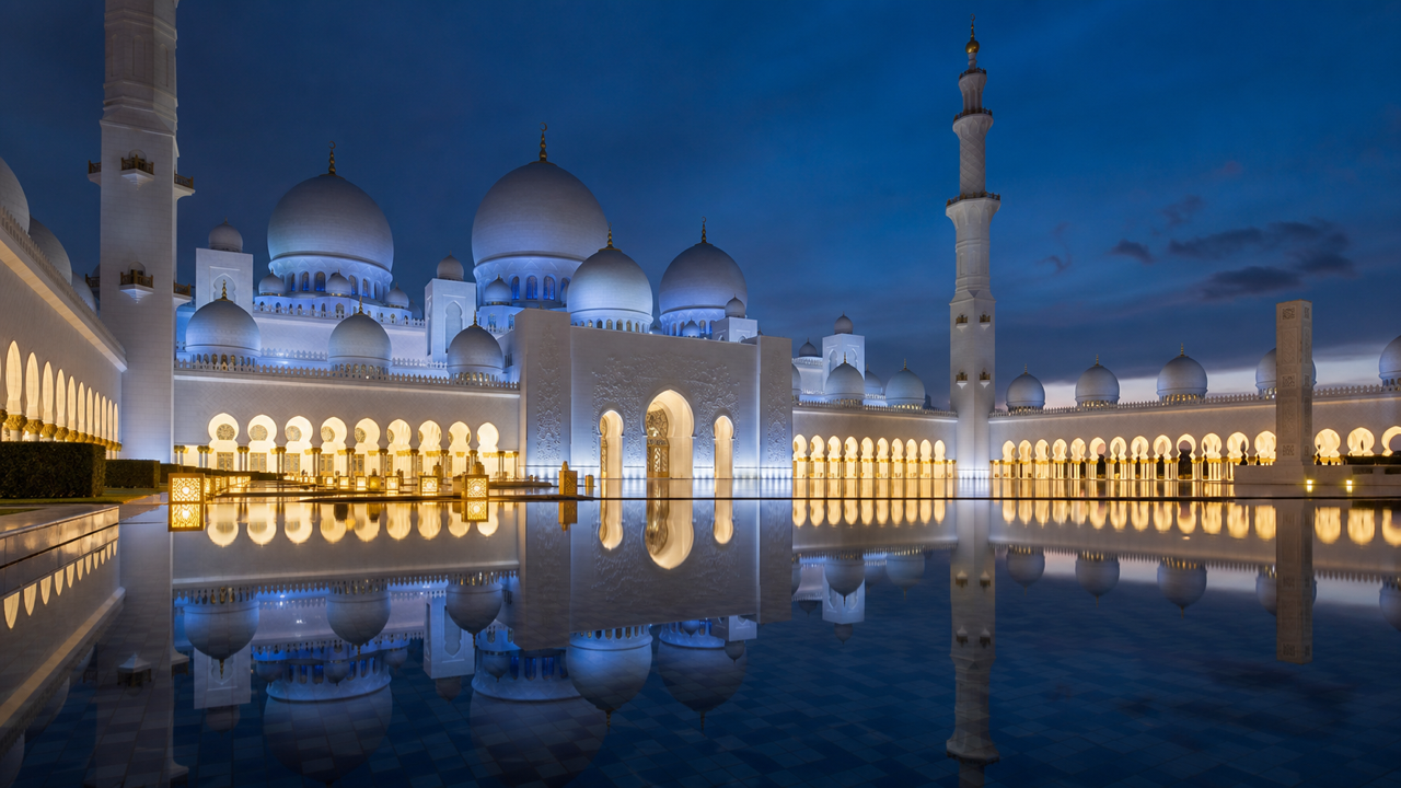 The white marble domes and courtyard of Sheikh Zayed Grand Mosque in Abu Dhabi